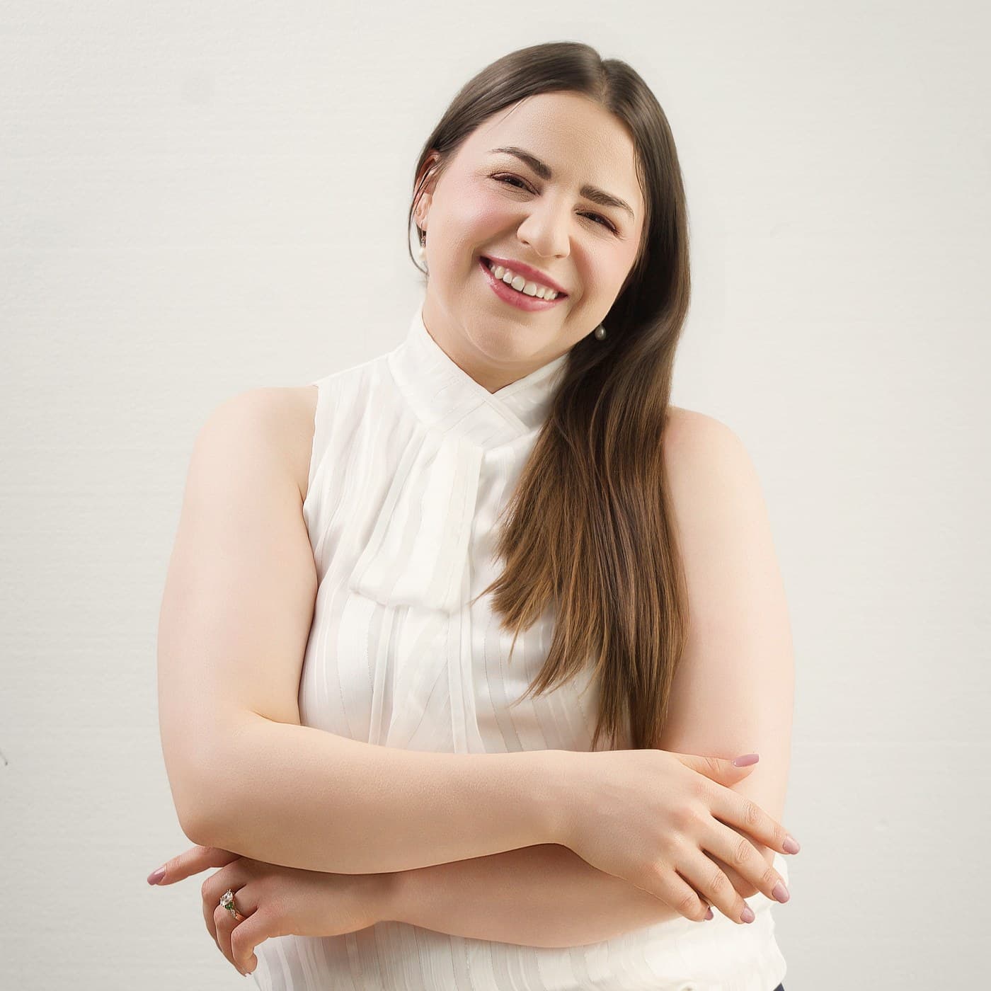 Hannah Parks, a Licensed Professional Counselor, smiling with her arms folded.